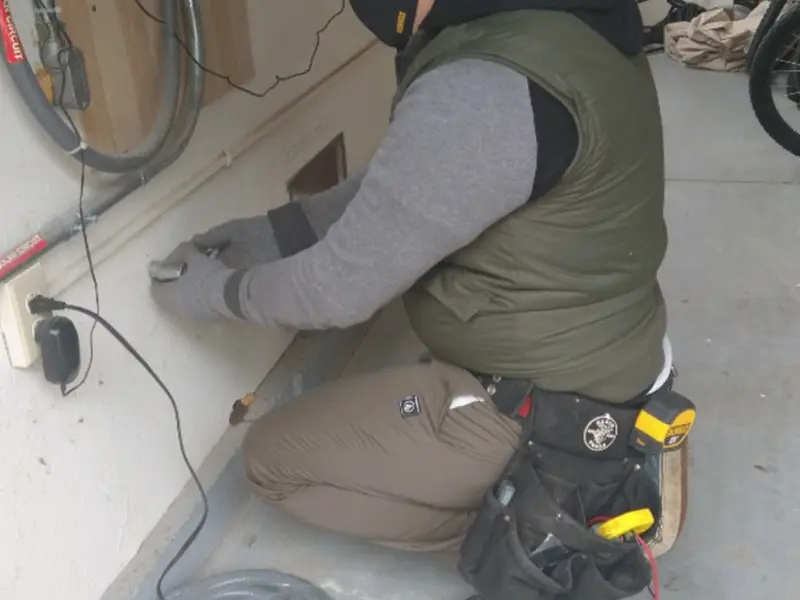 Electrician performing outlet wiring in a Bisbee garage