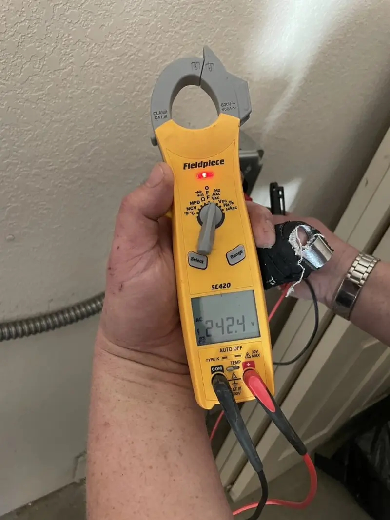 Voltage testing with clamp meter during Ceiling Fan Installation in Bisbee